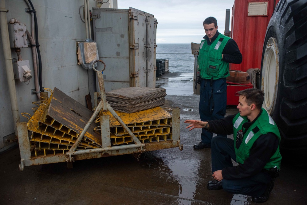 USS Ronald Reagan (CVN 76) Sailors transport gear on the flight deck