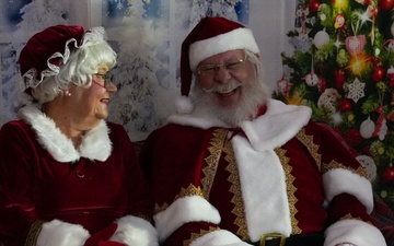 Santa Clause shares a laugh with his spouse, Mrs. Clause