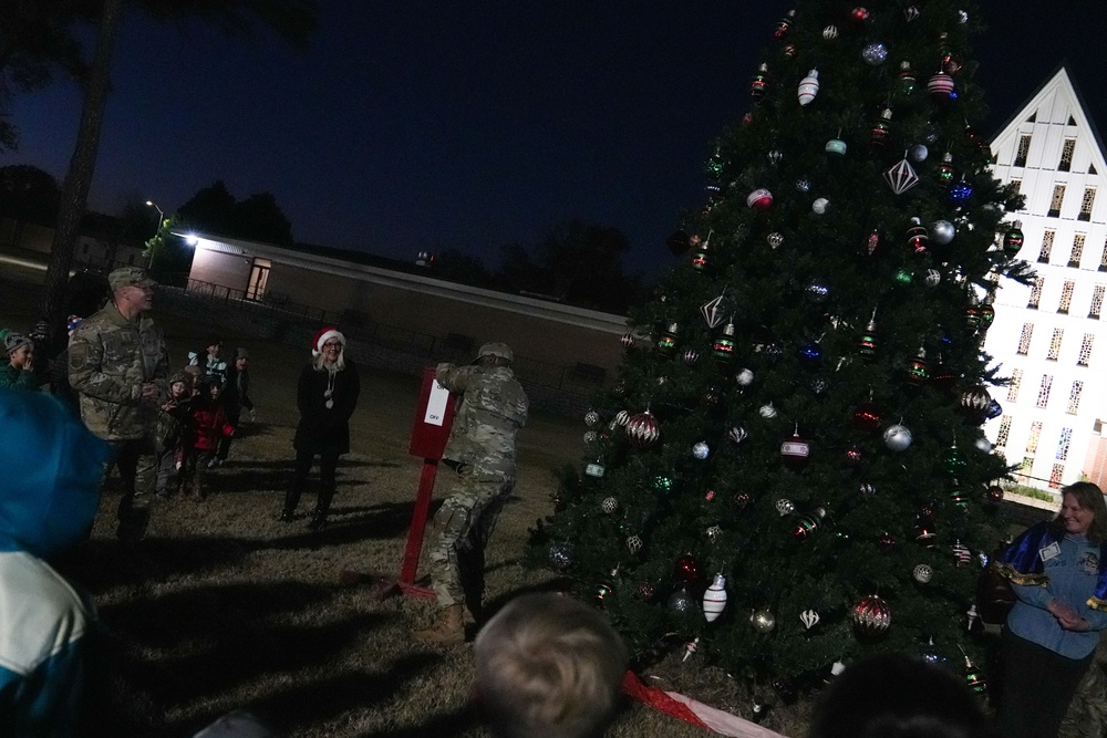 Col. Deedrick Reese, Robins Installation and 78th Air Base Wing commander, flips the switch to officially bring in the holidays at the Winter Market and Tree Lighting Ceremony at Robins Air Force Base.