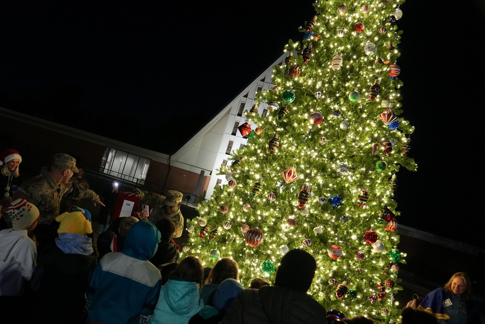 Col. Deedrick Reese, Robins Installation and 78th Air Base Wing commander, along with Team Robins children, illuminate the base Christmas tree.