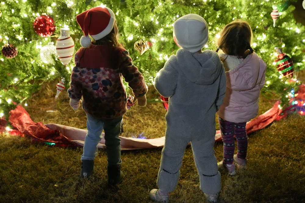 Team Robins children take in the Christmas tree decorations, tinsel and lights.