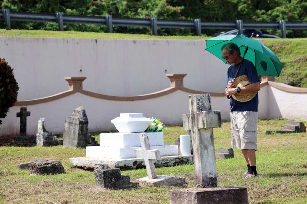 Public Access Program Tour Participant Pays Respects at Sumay Cemetery