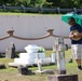 Public Access Program Tour Participant Pays Respects at Sumay Cemetery