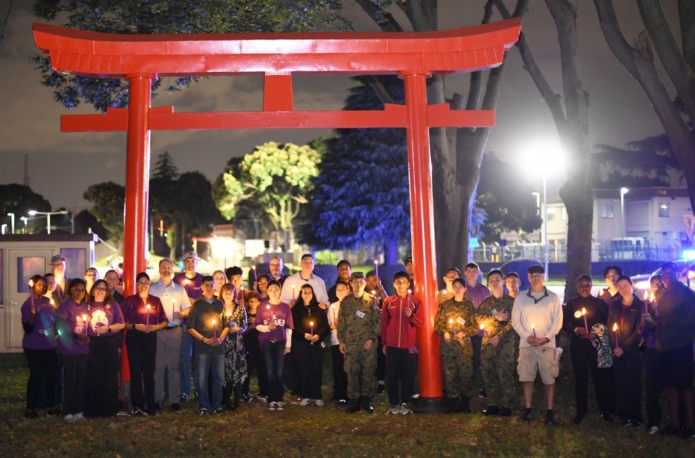 Camp Zama community shines light on domestic violence awareness with candlelight vigil walk