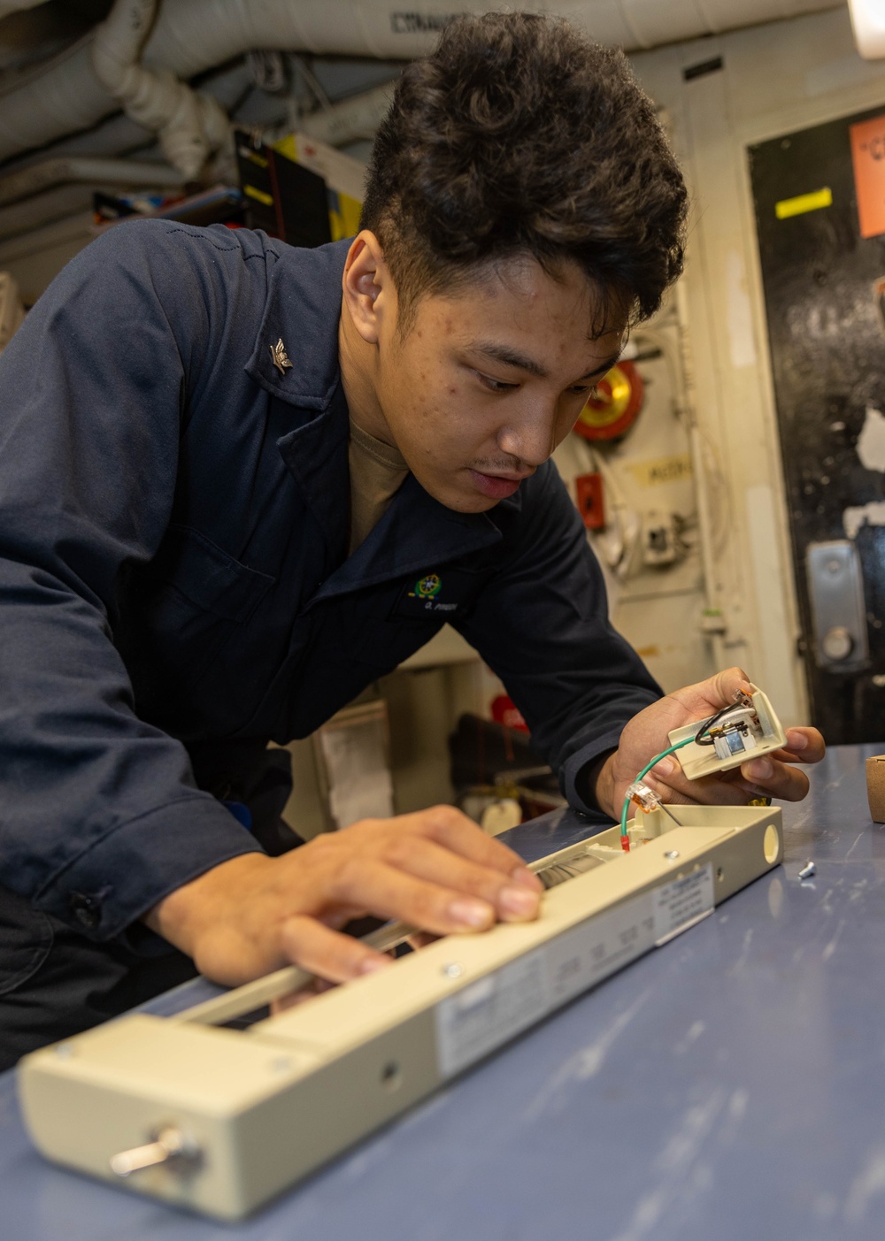 EM2 Dean Pineda Inspects Rack Receptacle