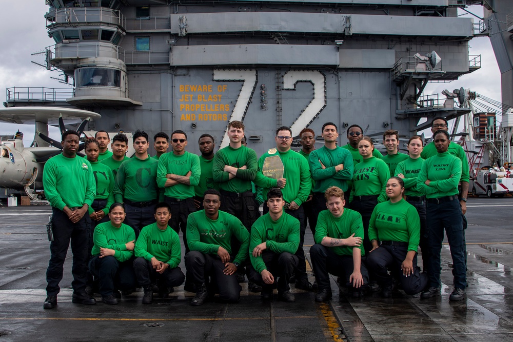 Abraham Lincoln’s catapult crew poses on the flight deck