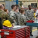 Kirk Kitchens, 573rd Manufacturing Squadron Machine Shop flight chief, explains 3-D printing techniques and their uses in depot level aircraft maintenance to members of the Civil Air Patrol