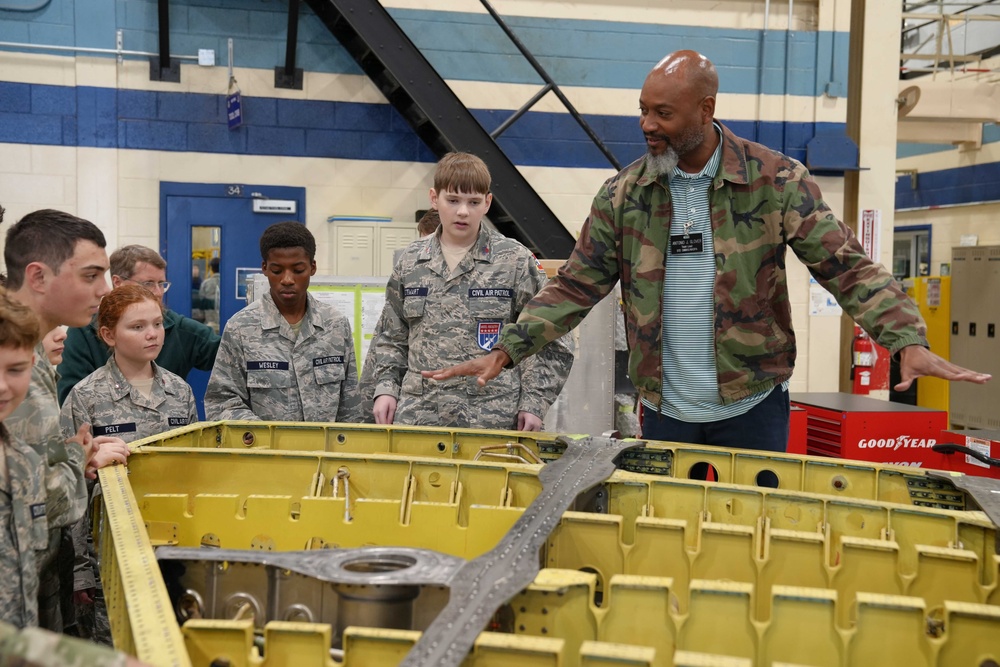 Antonio Glover, 572nd Commodities Maintenance Squadron Maintenance Defense Production Act team lead, explains fabrication efforts of a F-15E fighter jet wing to members of the Civil Air Patrol