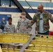 Antonio Glover, 572nd Commodities Maintenance Squadron Maintenance Defense Production Act team lead, explains fabrication efforts of a F-15E fighter jet wing to members of the Civil Air Patrol