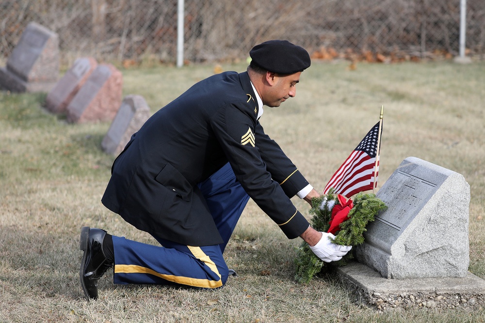 Army Reserve Soldiers lay wreaths for veterans dating back to the Revolutionary War