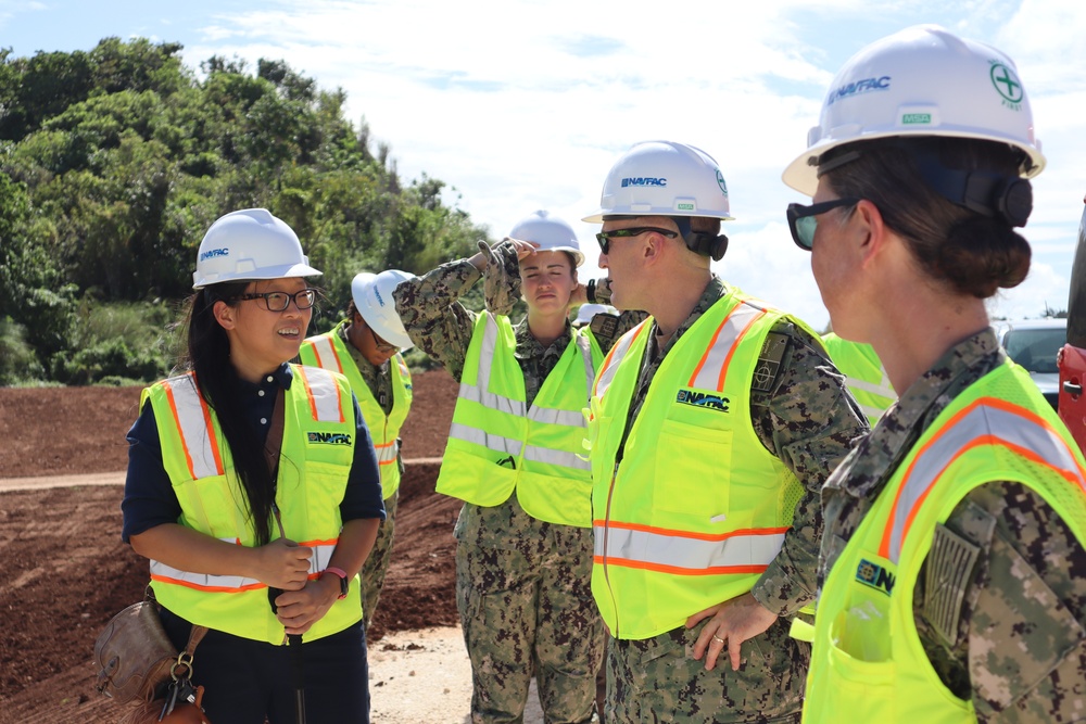 A construction manager briefs the Commander of NAVFAC Pacific at the site of a machine gun range under construction