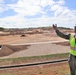 The Commanding Officer of OICC Marine Corps Marianas discusses construction progress at a machine gun range