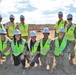 NAVFAC staff pose for a photo during a site visit