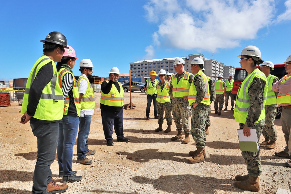 Contractors greet Rear Adm. Jeffrey Kilian on a project under construction on Marine Corps Base Camp Blaz