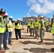 Contractors greet Rear Adm. Jeffrey Kilian on a project under construction on Marine Corps Base Camp Blaz