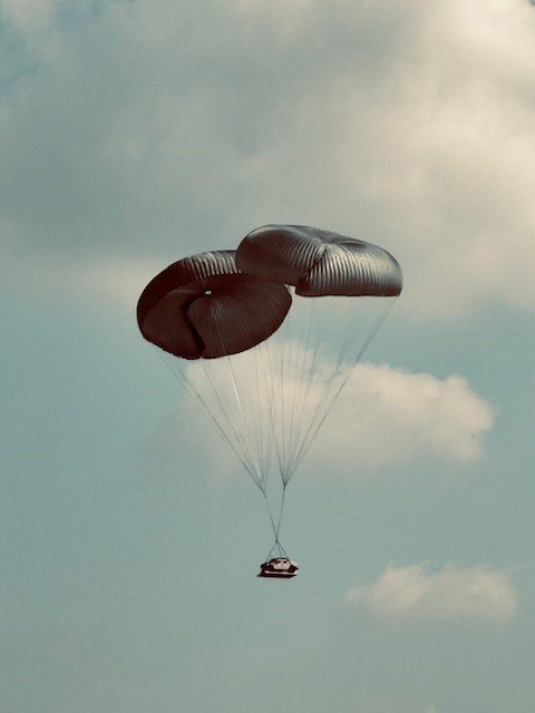 U.S. Army M1097A1 550-1000ft Above Ground Level (AGL), descending after successful parachute deployment