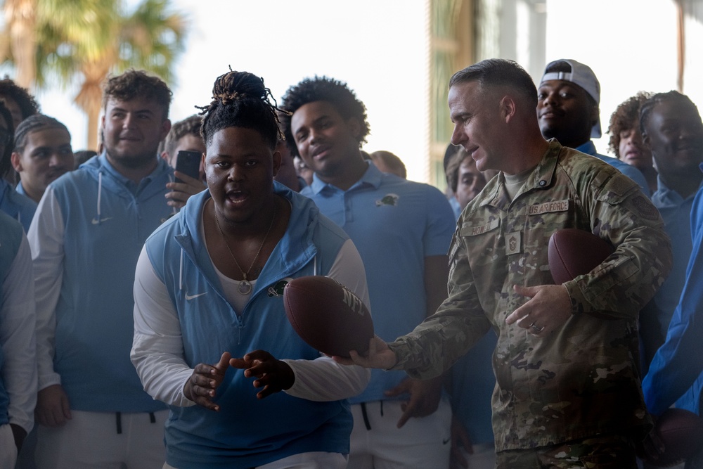 UF Gators and TU Green Wave football teams visit MacDill AFB ahead of Gasparilla Bowl