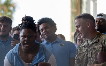 UF Gators and TU Green Wave football teams visit MacDill AFB ahead of Gasparilla Bowl