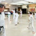 Black belts and boundary lines: Real estate specialist lives a double life of discipline and defense