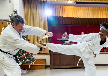 Black belts and boundary lines: Real estate specialist lives a double life of discipline and defense