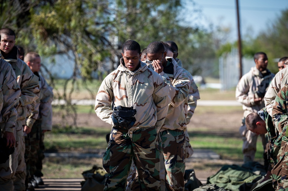 Trainees assigned to flights 100-103 participate in Mask Confidence Training Dec. 19, 2024