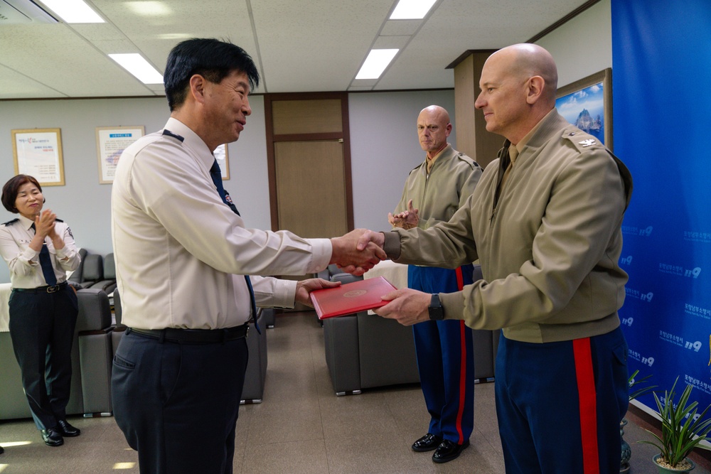 Col. Ronnie D. Michael, awards Mr. Ryu Deuk Gon Pohang Nambu Fire Station Chief with the Certificate of Commendation