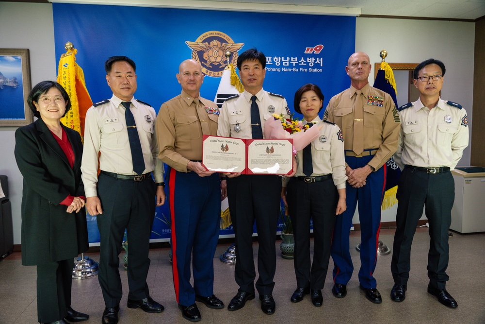 Col. Ronnie D. Michael, awards Mr. Ryu Deuk Gon Pohang Nambu Fire Station Chief with the Certificate of Commendation