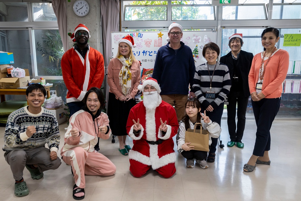 U.S. Marine Corps gives gifts to a local shelter in the city of Naha through Merry Marine Toy Drive