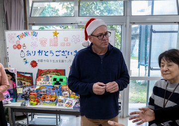 U.S. Marine Corps gives gifts to a local shelter in the city of Naha through Merry Marine Toy Drive