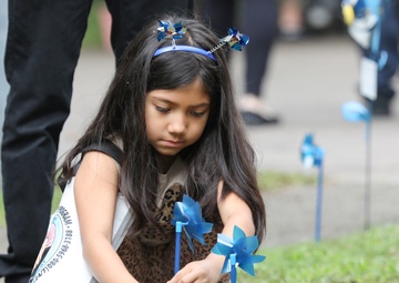 Youth display pinwheels to promote prevention of child abuse