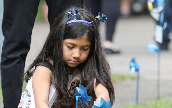 Youth display pinwheels to promote prevention of child abuse