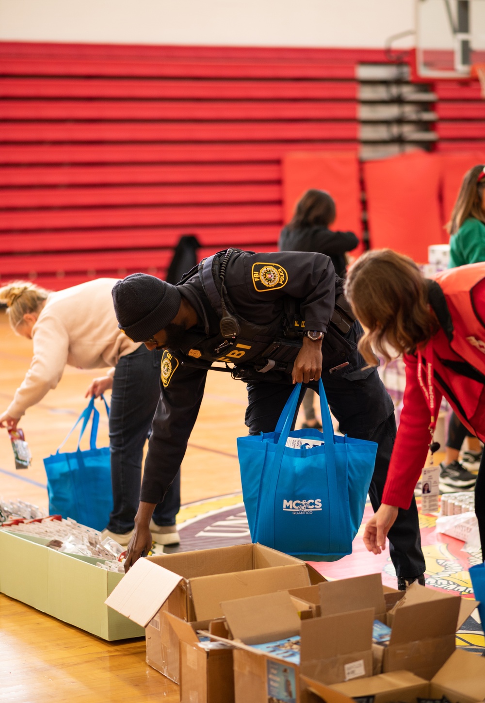 Volunteers pack gift bags for Holidays in the Barracks event