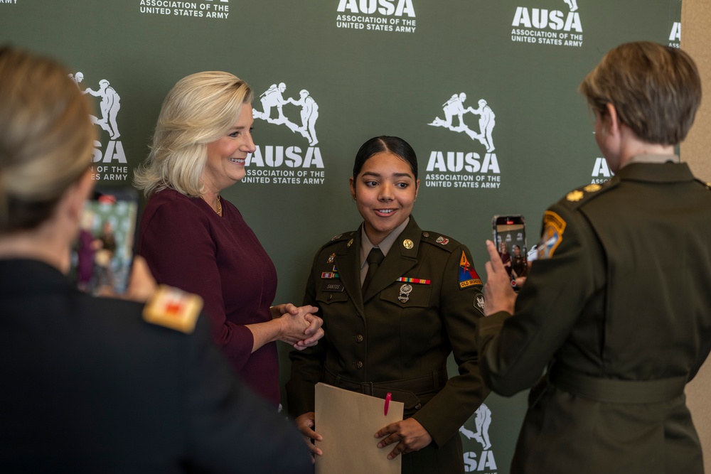 Secretary of the Army, Hon. Christine Wormuth, films a video with U.S. Army Spc. Dunia following a rountable discussion with U.S. Army social media influencers during the 2024 Association of the U.S. Army Annual Meeting and Exposition