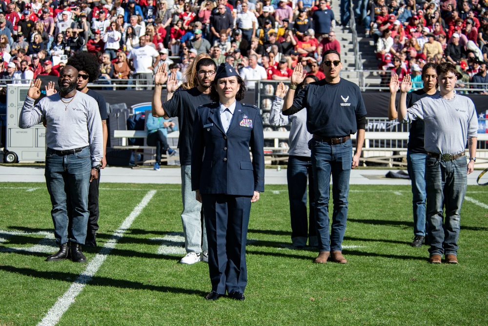 Recruits swear into the U.S. Air Force during the 2024 Lockheed Martin Armed Forces Bowl