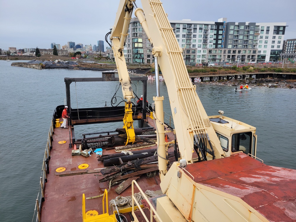 Raccoon crew removes hazards in Oakland Estuary