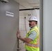 Safety personnel inspect showers during a safety inspection of H-2B visa worker barracks