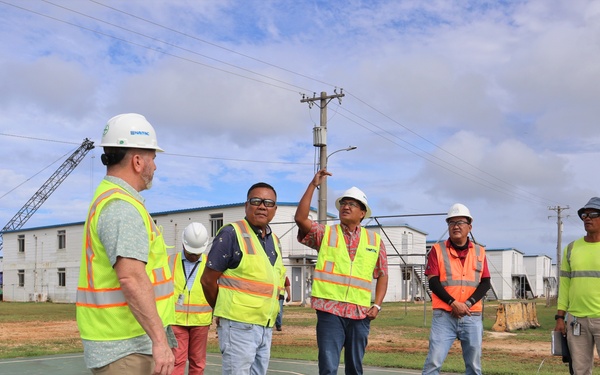 Safety personnel inspect a basketball court for H-2B visa workers on contractor-owned facilities