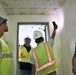 Safety personnel with the Office in Charge of Construction highlight safety concerns during a tour of H-2B visa worker barracks on a contractor-owned facility