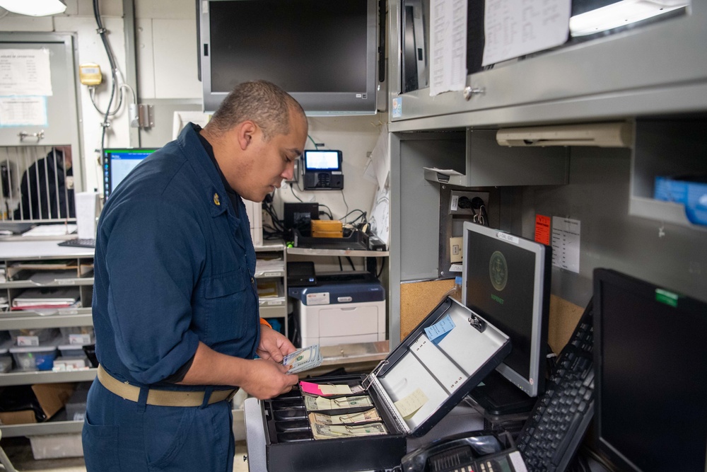 USS Ronald Reagan (CVN 76) Sailors process cash services