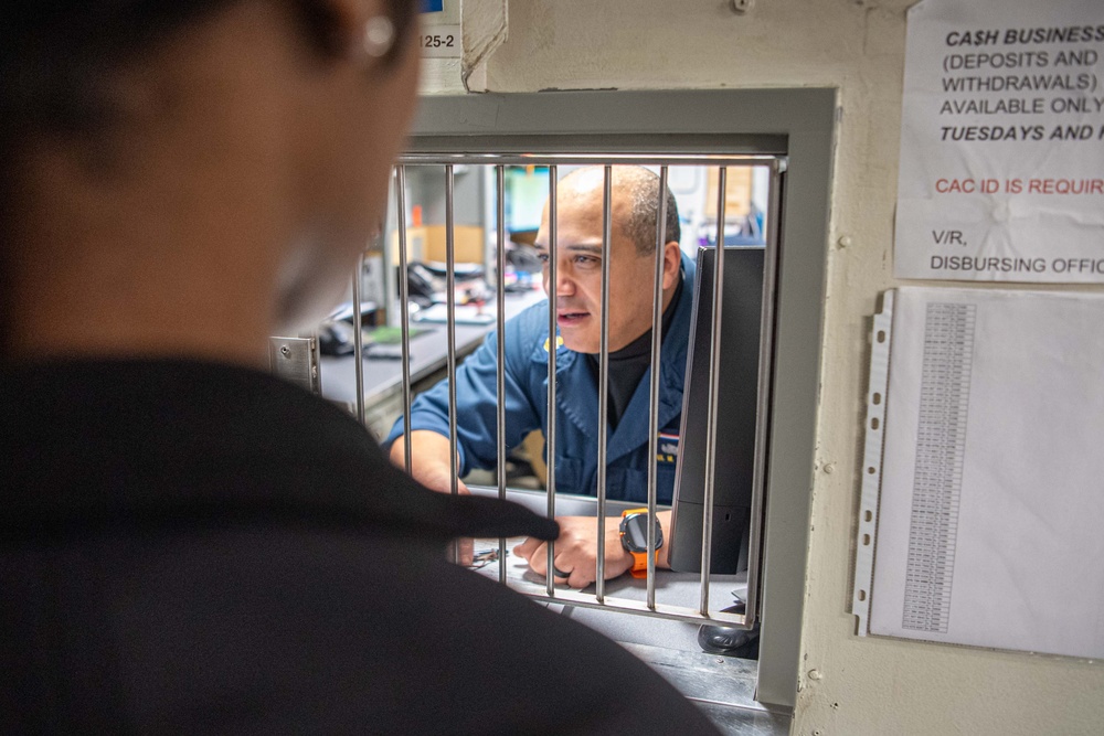 USS Ronald Reagan (CVN 76) Sailors process cash services