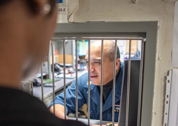 USS Ronald Reagan (CVN 76) Sailors process cash services