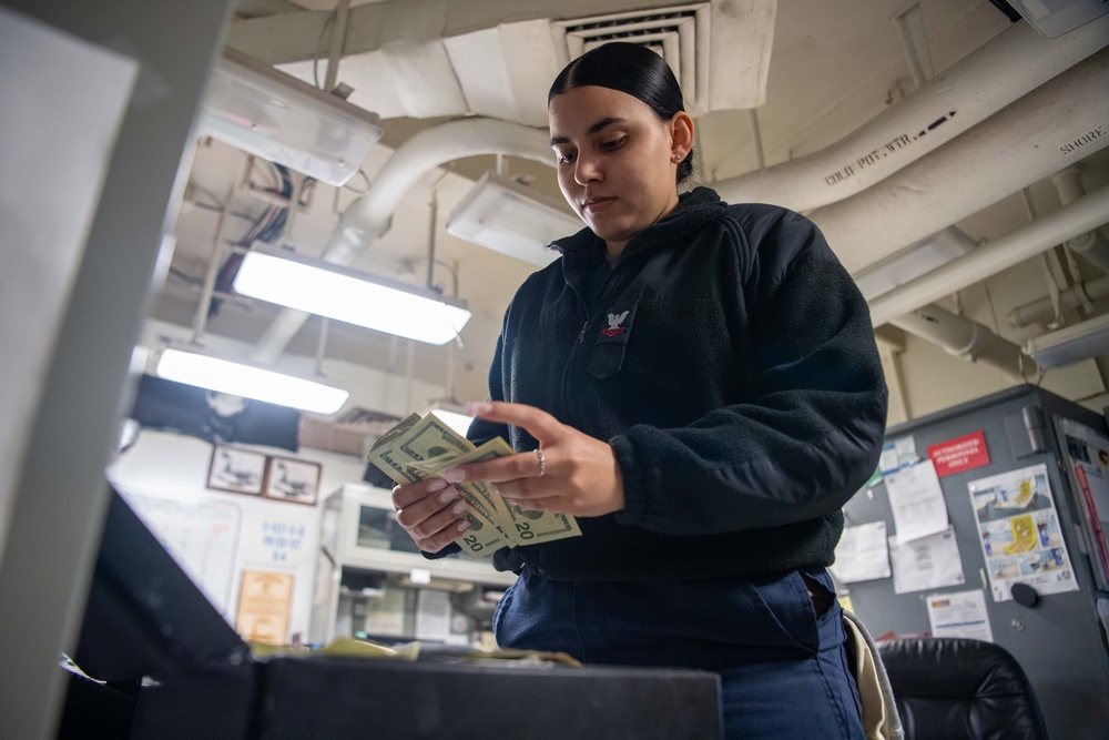 USS Ronald Reagan (CVN 76) Sailors process cash services