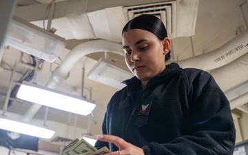 USS Ronald Reagan (CVN 76) Sailors process cash services