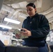 USS Ronald Reagan (CVN 76) Sailors process cash services