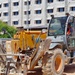 A forklift moves construction equipment during the construction of Bachelor Enlisted Quarters on Marine Corps Base Camp Blaz