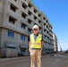 An Engineering Technician poses in front of his project on Marine Corps Base Camp Blaz