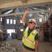 An Engineering Technician discusses key features in a community center under construction on Marine Corps Base Camp Blaz