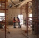 Contractors consult construction documents while making progress on a community center under construction on Marine Corps Base Camp Blaz