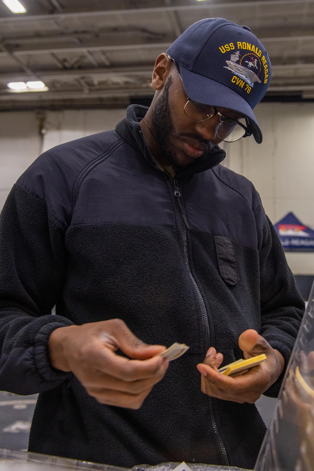 USS Ronald Reagan (CVN 76) Sailors issue personal protective equipment