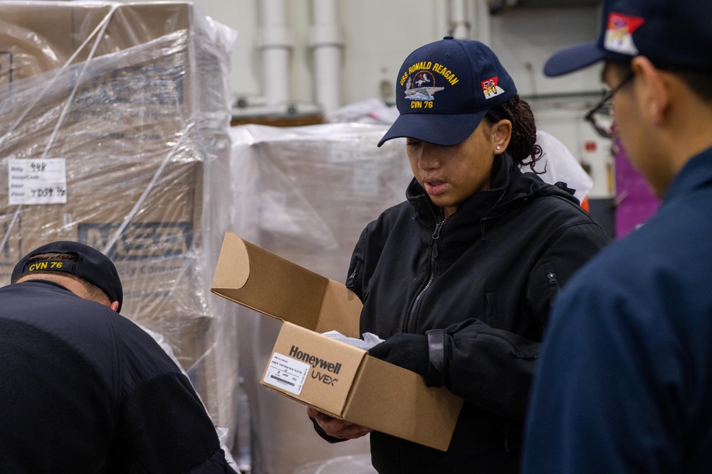 USS Ronald Reagan (CVN 76) Sailors issue personal protective equipment